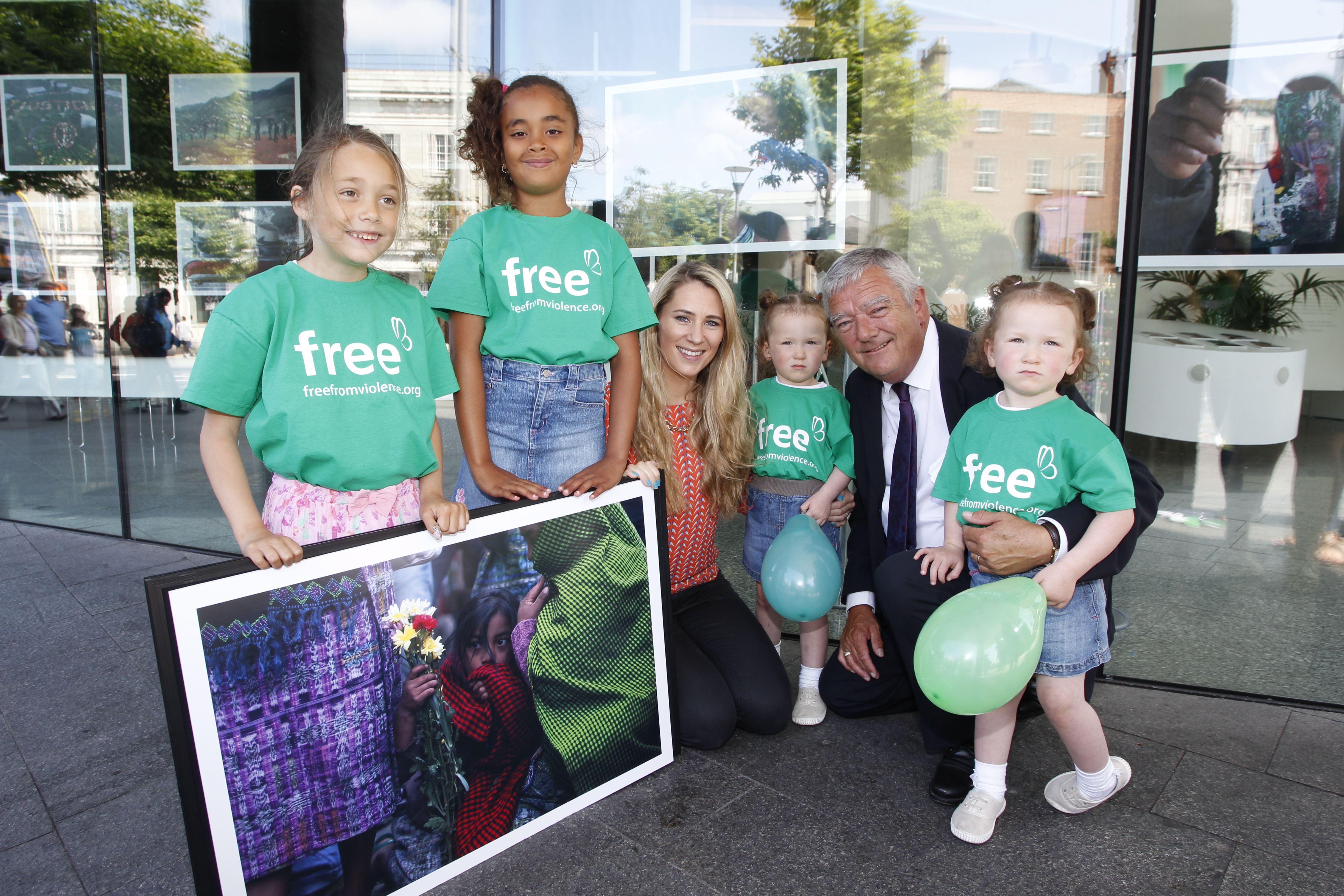 Mick Kiely, CEO of Childfund Ireland, with his twin granddaughers (about 4 years old) and a couple of older girls.