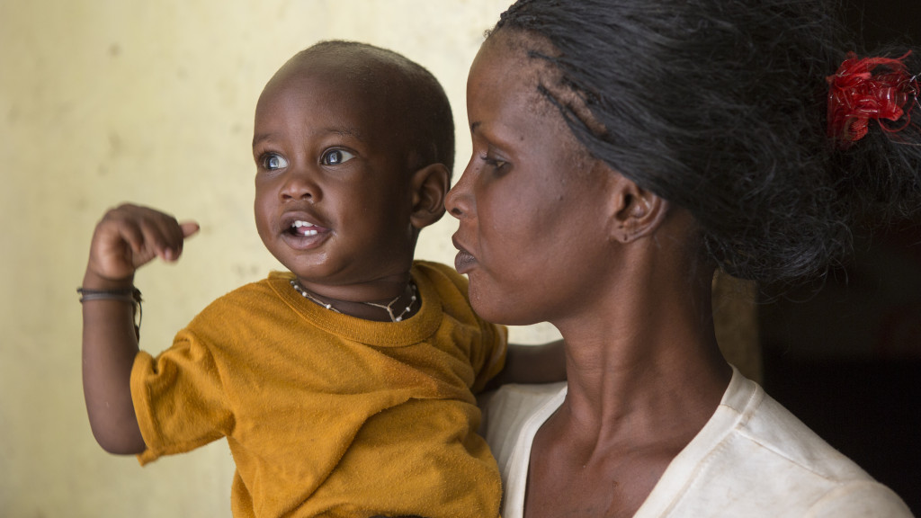 Awa Thian holds her 12-month-old son, Ndiaga, at their home in M'bour, Senegal. When community health volunteers identified Ndiaga as malnourished, he and his mother participated in a 10-day nutrition and recovery workshop. Today he is healthy and gaining weight. ChildFund International - Senegal.November 8, 2013.Photo by Jake Lyell