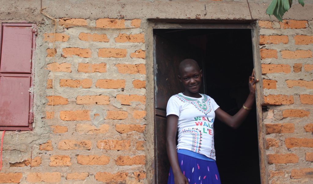 Lydia proudly displays her new dwelling